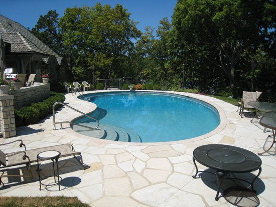 A fully renovated backyard pool with new decking and clear water.