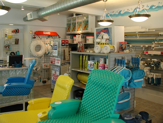 Pool floats, accessories, and gear stocked along an aisle of the store.